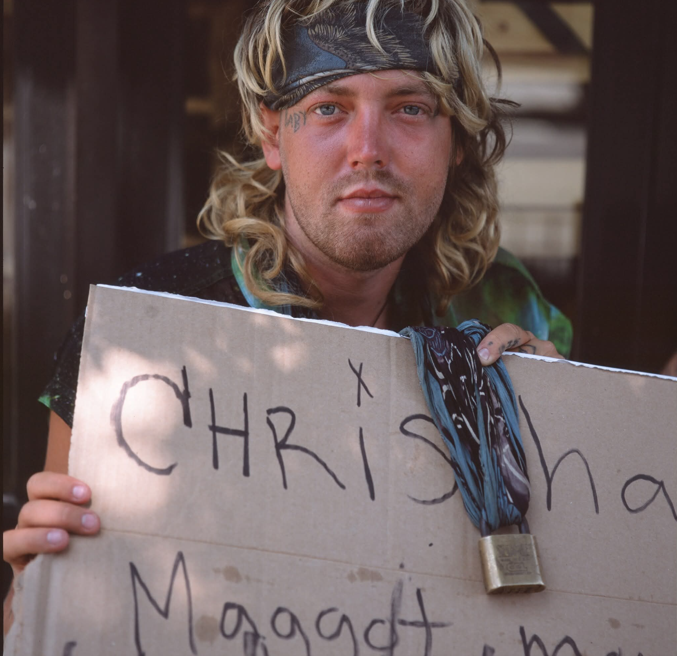 Simon holding a sign