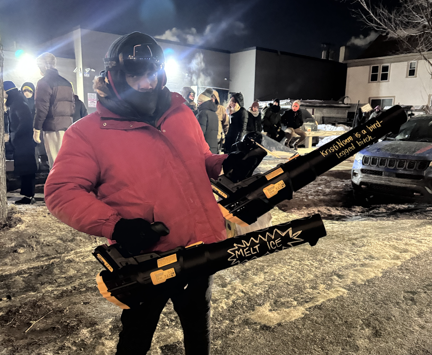 Man holding leaf blowers