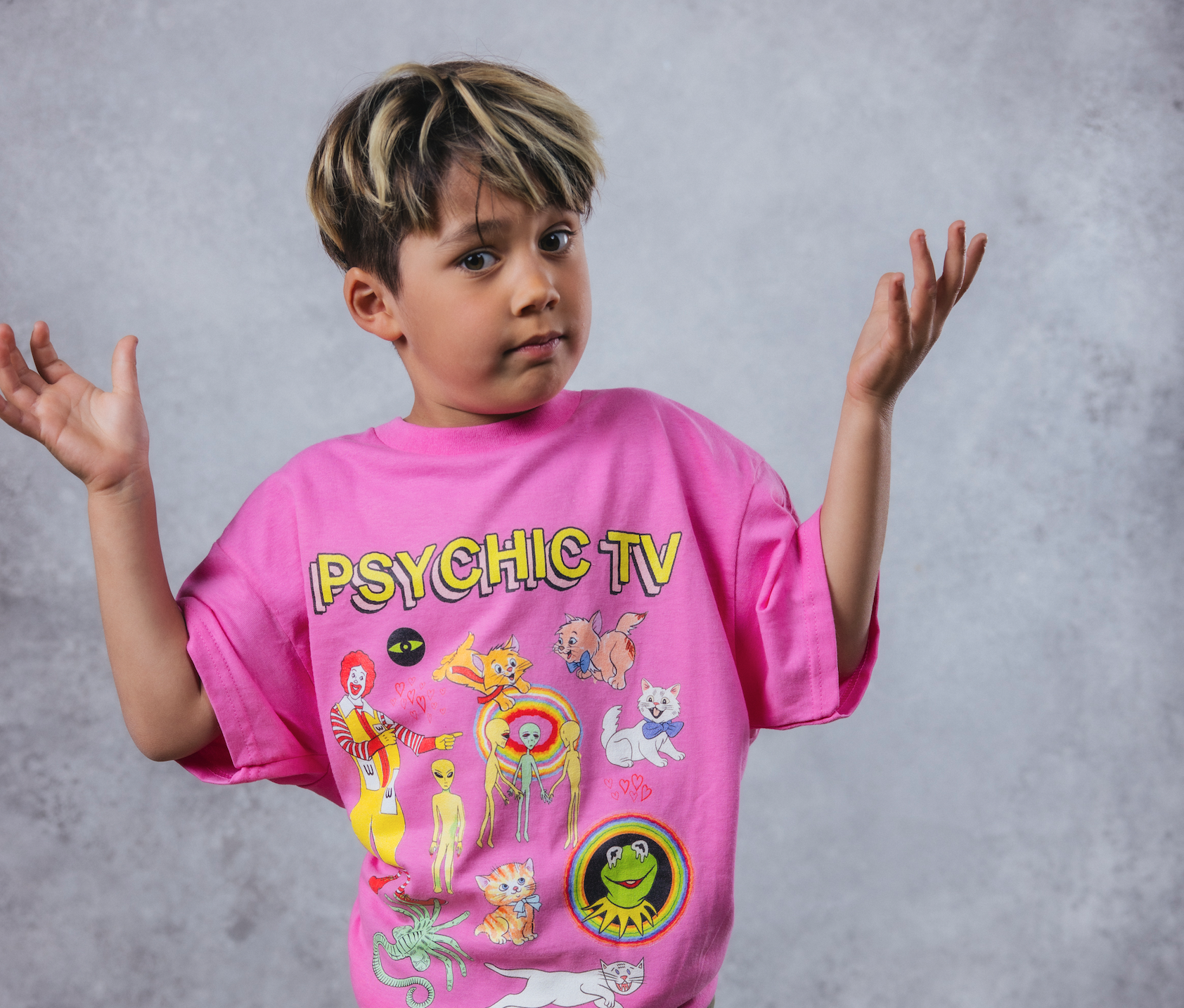 Pink shirt with the words "Psychic TV" at the top and illustrations of Kermit and cats and Ronald McDonald with upside down M's