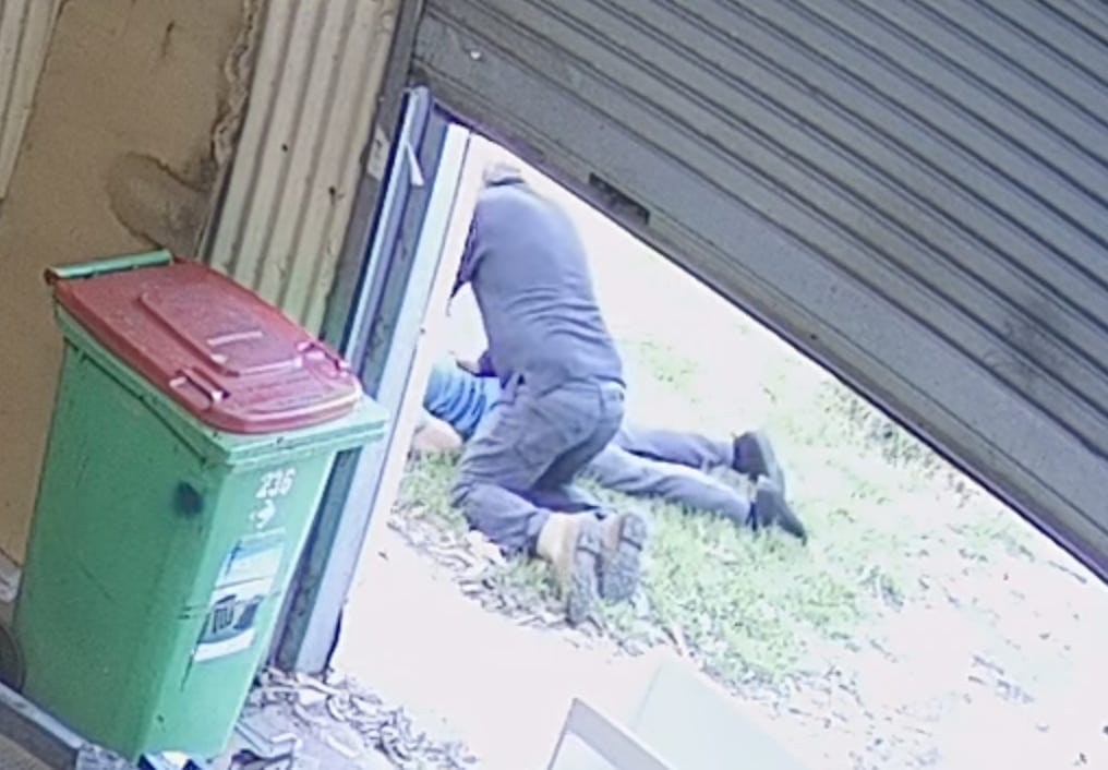 Man sitting on top of fake seizure guy