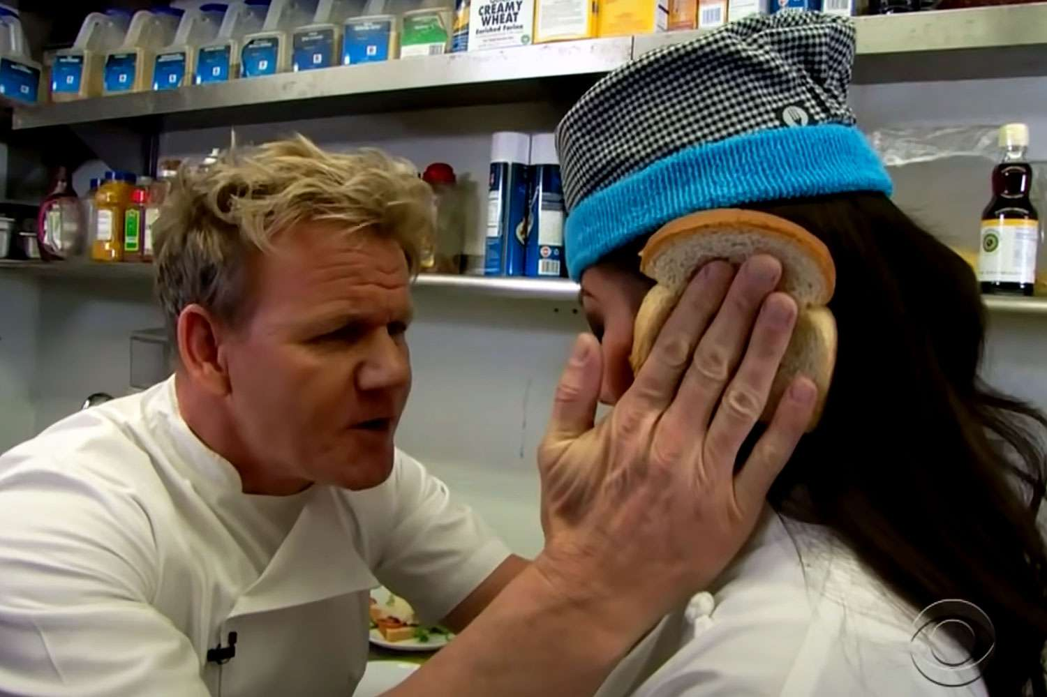 That angry chef from TV holding two bits of bread either side of a contestant's face