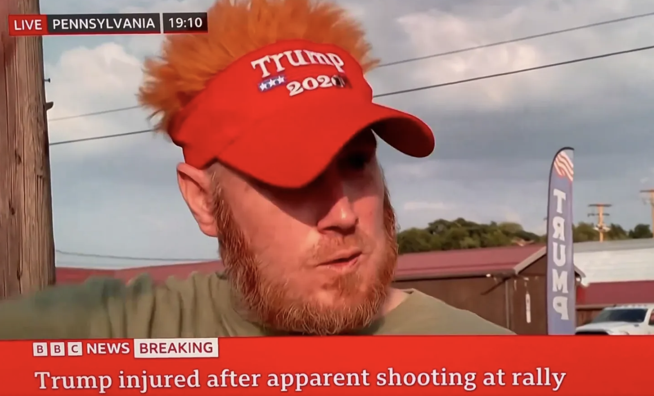 Man with orange hair and Trump hat