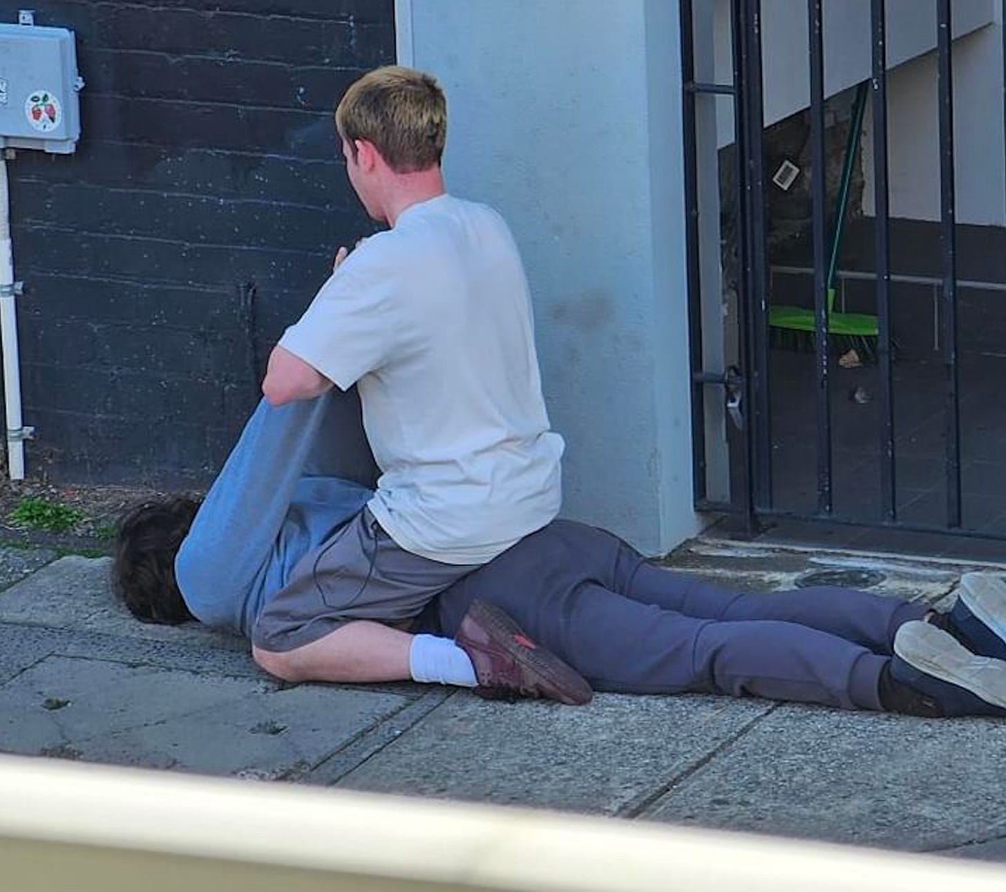 Man sitting on top of a man 